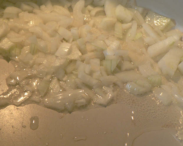 Chopped onions frying on a skillet