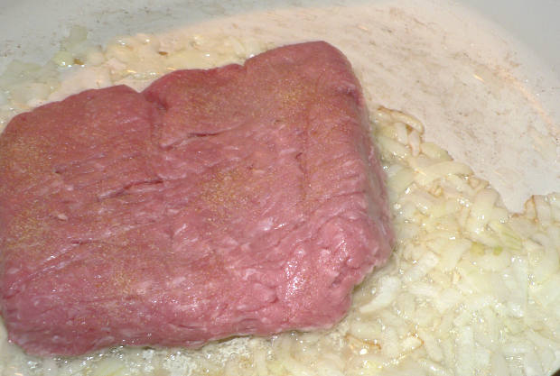 Ground turkey with onions on a skillet