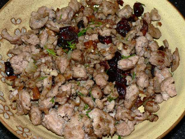 Turkey, pecans, cranberries, dill on a yellow plate