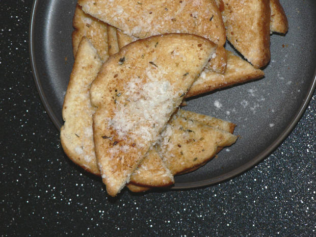 Garlic Bread Cut Into Halves on a Plate