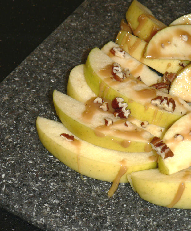 Apples and Carmel Sauce on a Cutting Board