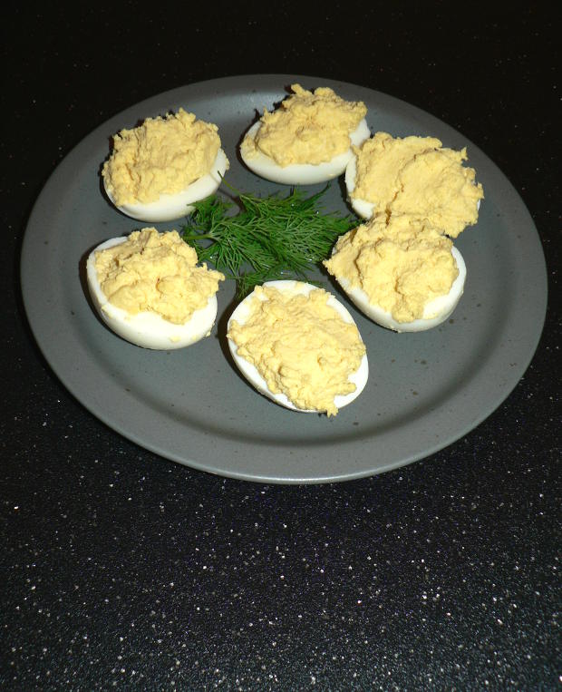 Deviled Eggs on a grey plate with dill