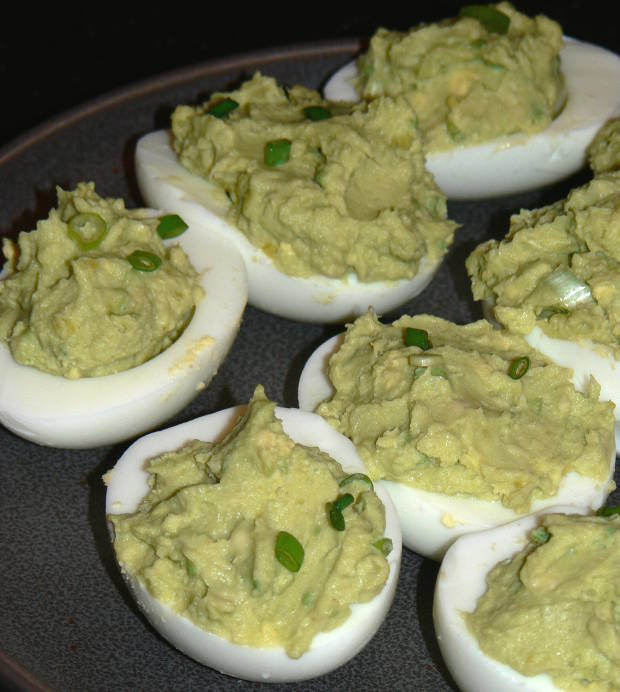 Green Deviled Eggs on a grey plate