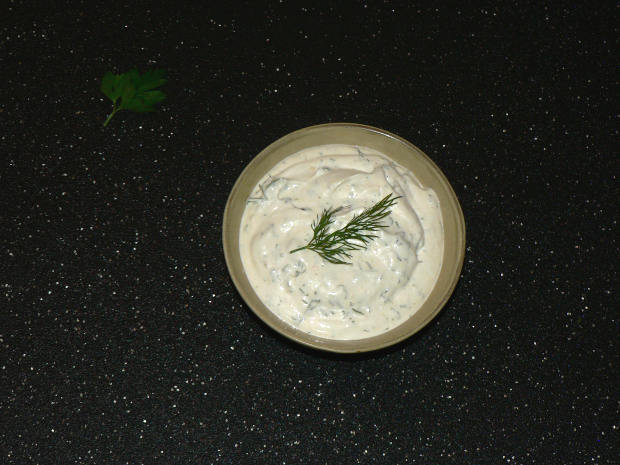 Healthy Ranch Dressing In A Bowl on a black cutting board