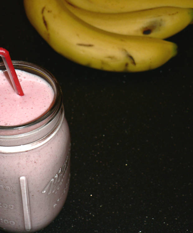 Strawberry Banana Smoothie With Bananas in the Background