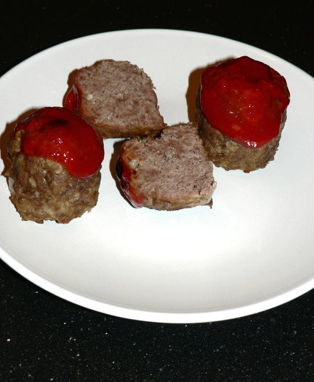 Mini meatloaves cut into halves on a white plate
