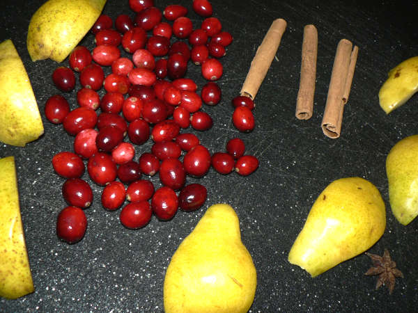 Pears, Cranberries, Cinnamon Sticks on a Cutting Board
