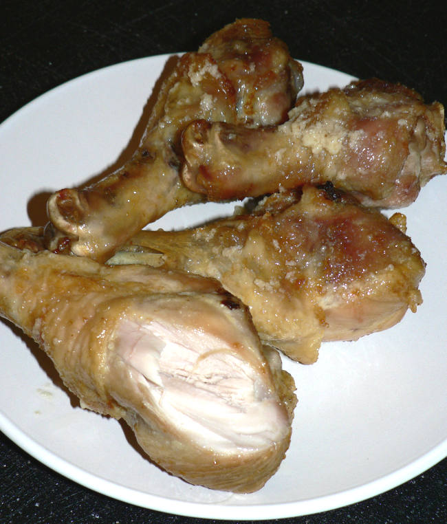 Parmesan Garlic Chicken Legs on a White Plate