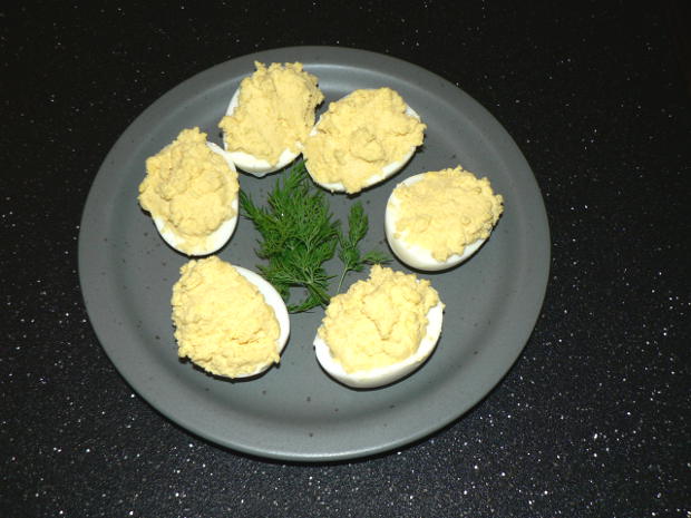 Deviled Eggs on a grey plate with dill