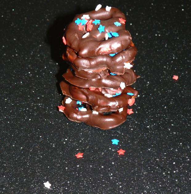 Patriotic Chocolate Covered Pretzels Stacked on a Black Surface