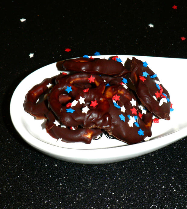 Chocolate Pretzels in a White Dish on a Black Cutting Board
