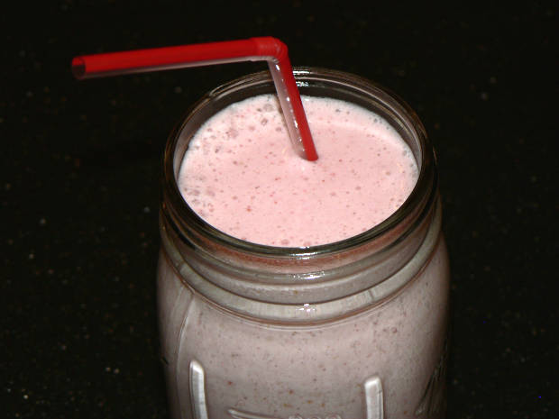 Banana Strawberry Smoothie With A Red Straw