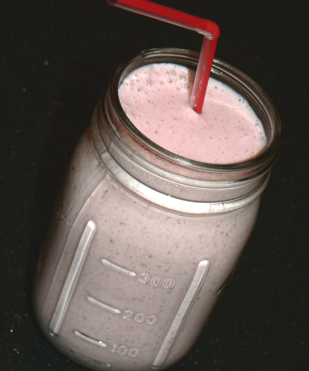 Strawberry Banana Smoothie In A Glass With A Straw