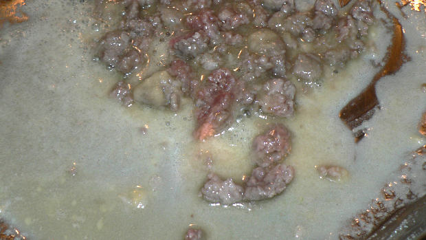 Meat, butter, flour on a stainless steel skillet