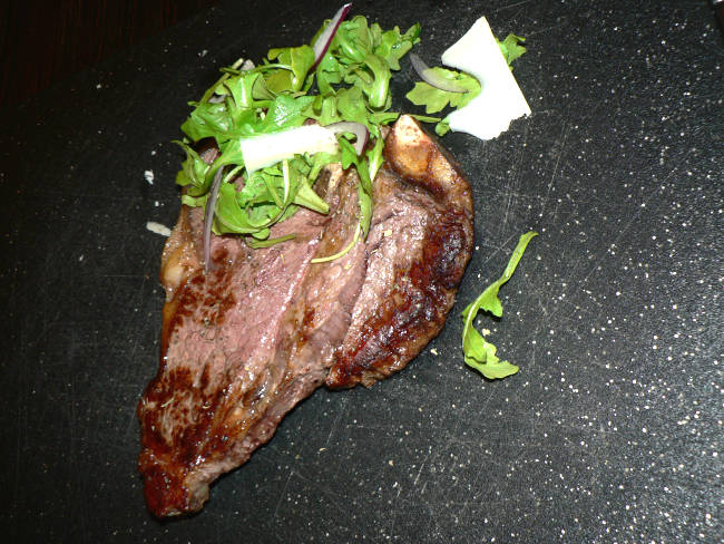 T-bone Steak on a black cutting board