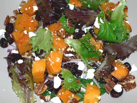 Onions, Lettuce, Cranberries, Goat Cheese, Butternut Squash Mixed in a Bowl