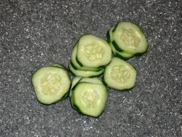 Cucumbers cut into rounds on a cutting board
