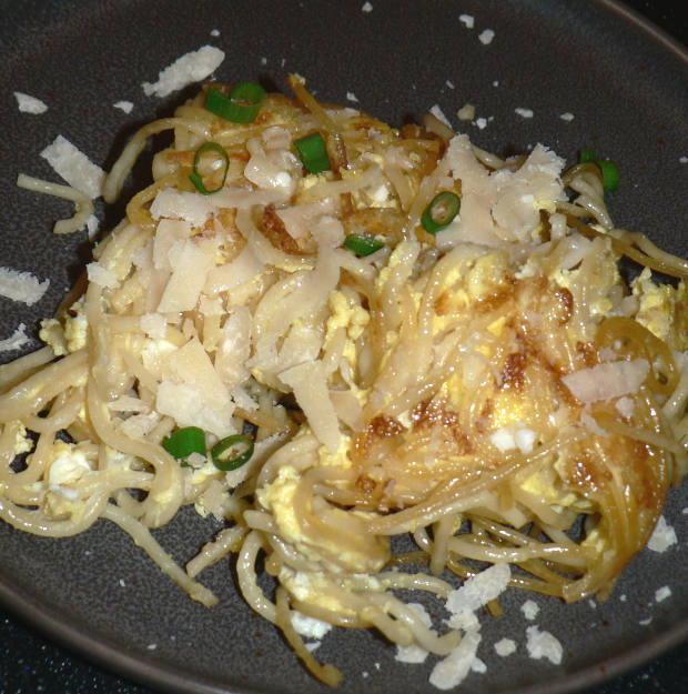 Spaghetti and scrambled eggs on a grey plate